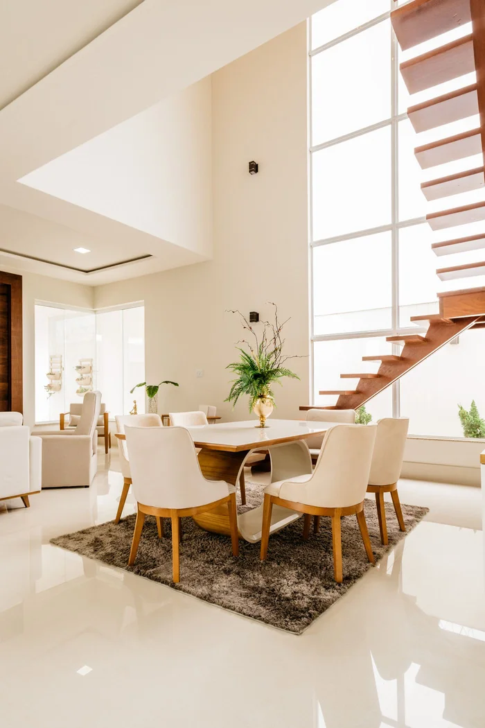 Natural wood, linen chairs and daylight in a photographed dining room